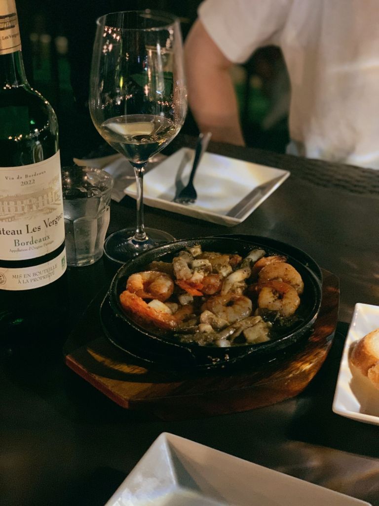 A glass of fine wine paired with a delicious platter and appetizers at Mullae Chin Chin wine bar.