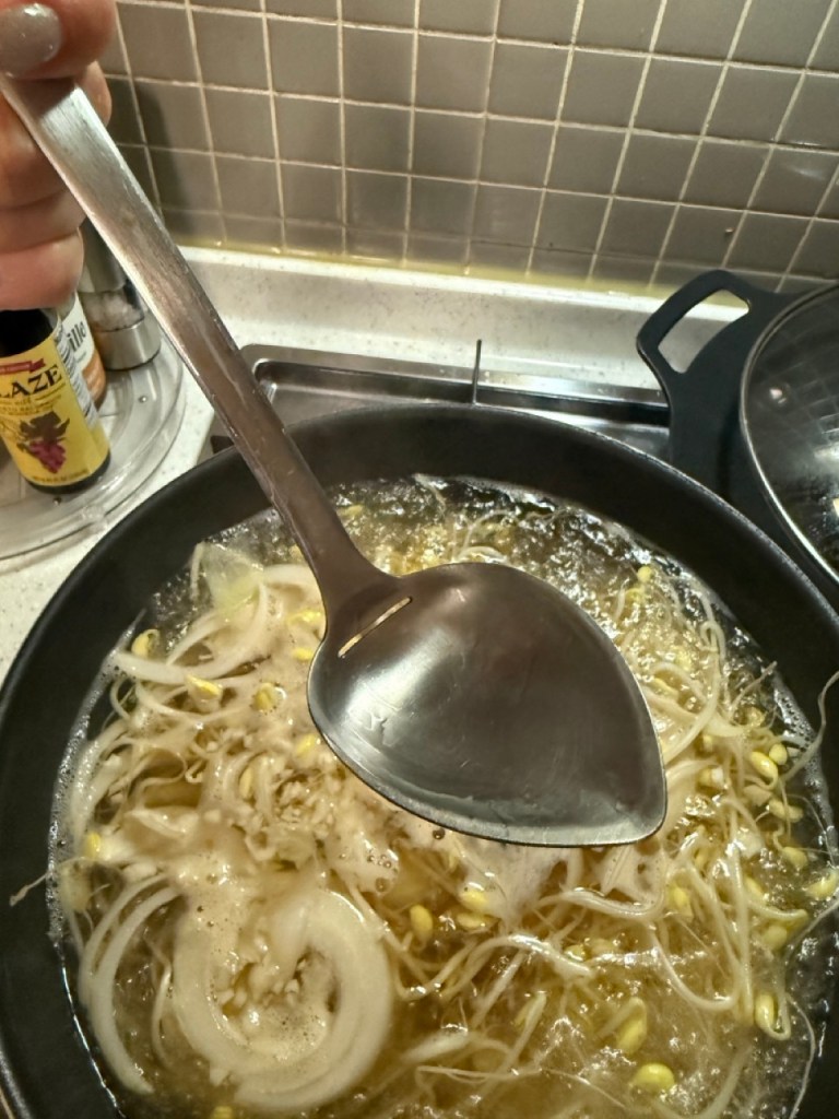 Carefully skimming off the white foam and cloudy residue from the surface with a spoon for a crystal-clear broth.