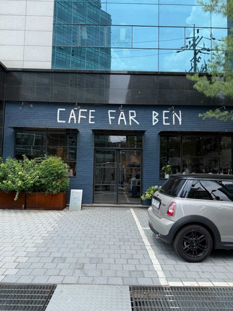 The sleek, wide minimalist exterior facade of FAR BEN, welcoming large group travelers in Seongsu-dong.
