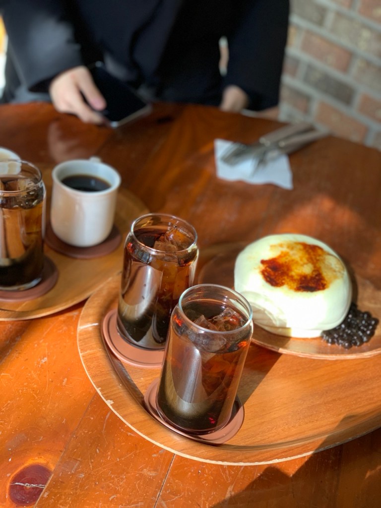 Pouring a rich, velvety sweet cream layer over freshly made stacked souffles at the trending Seongsu-dong hotspot.