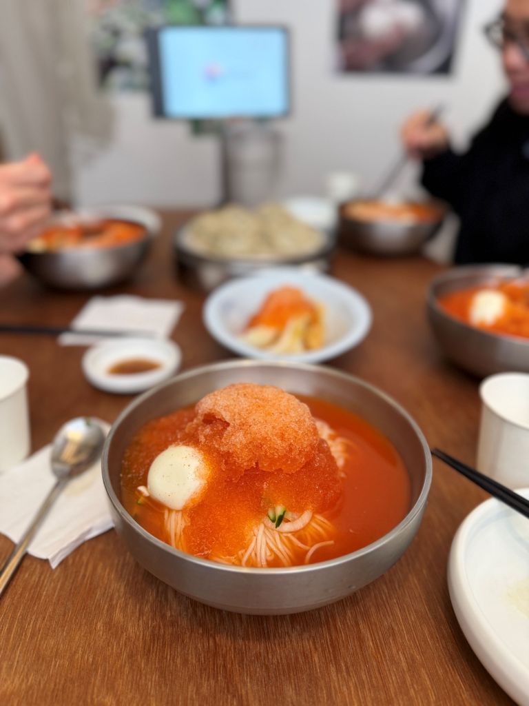 A bowl of ice-cold Korean Dongchimi noodles with slushy radish water kimchi broth, perfect for hot summer days in Seongsu-dong.