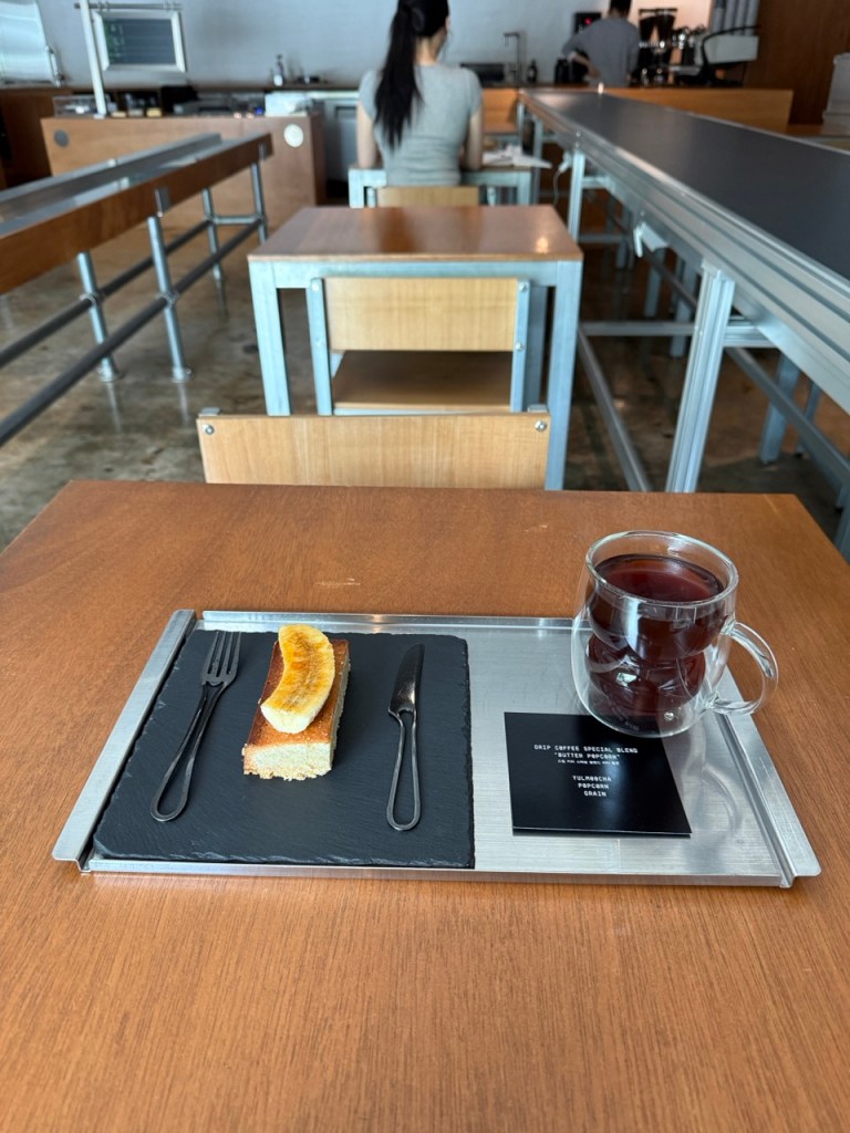 A beautifully presented iced specialty coffee and avant-garde dessert serving as the perfect fuel for a long working session.