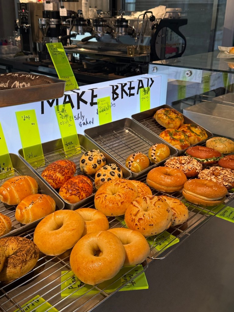 A mouthwatering top-down view of freshly baked artisanal pastries and desserts beautifully arranged at Cafe M Comma.
