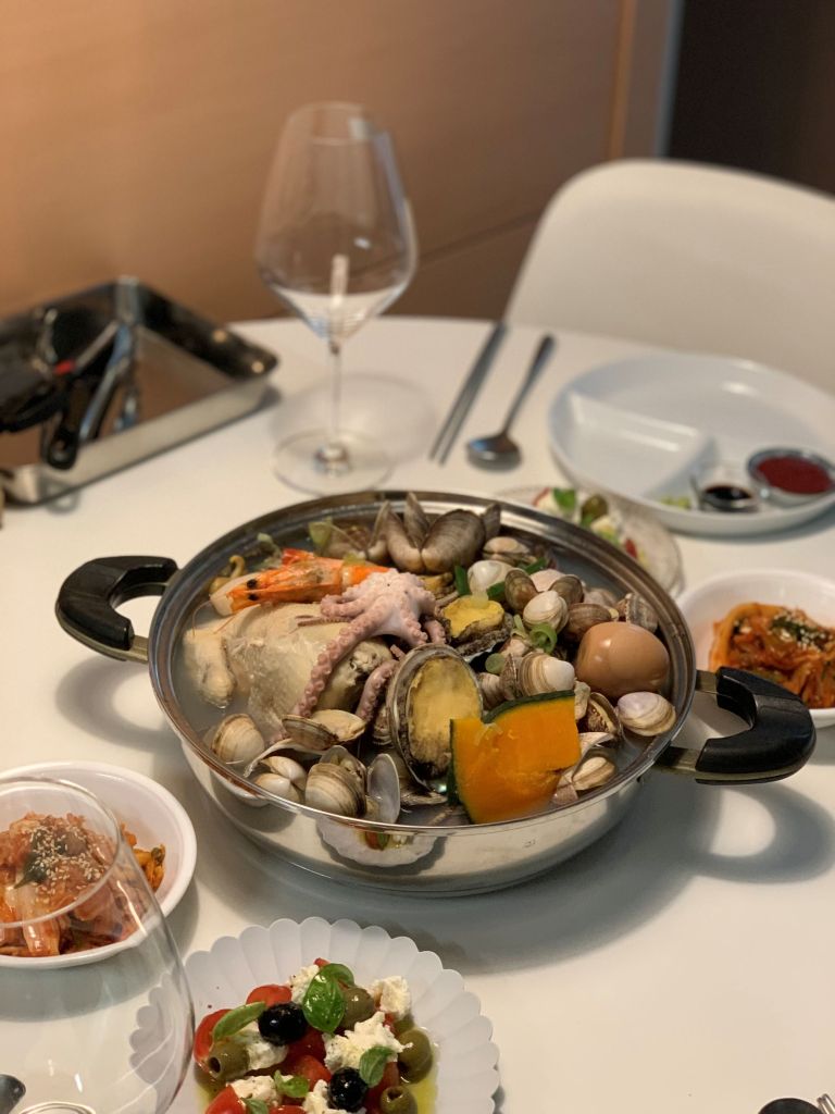 A lavish presentation of Haeshintang, featuring premium whole chicken loaded with fresh octopus, abalones, and scallops.