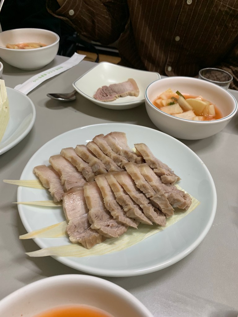 A magnificent tabletop display of signature luxury appetizers including shrimp pancakes (Jeon) and boiled beef (Suyuk) at Hanseong Kalguksu.