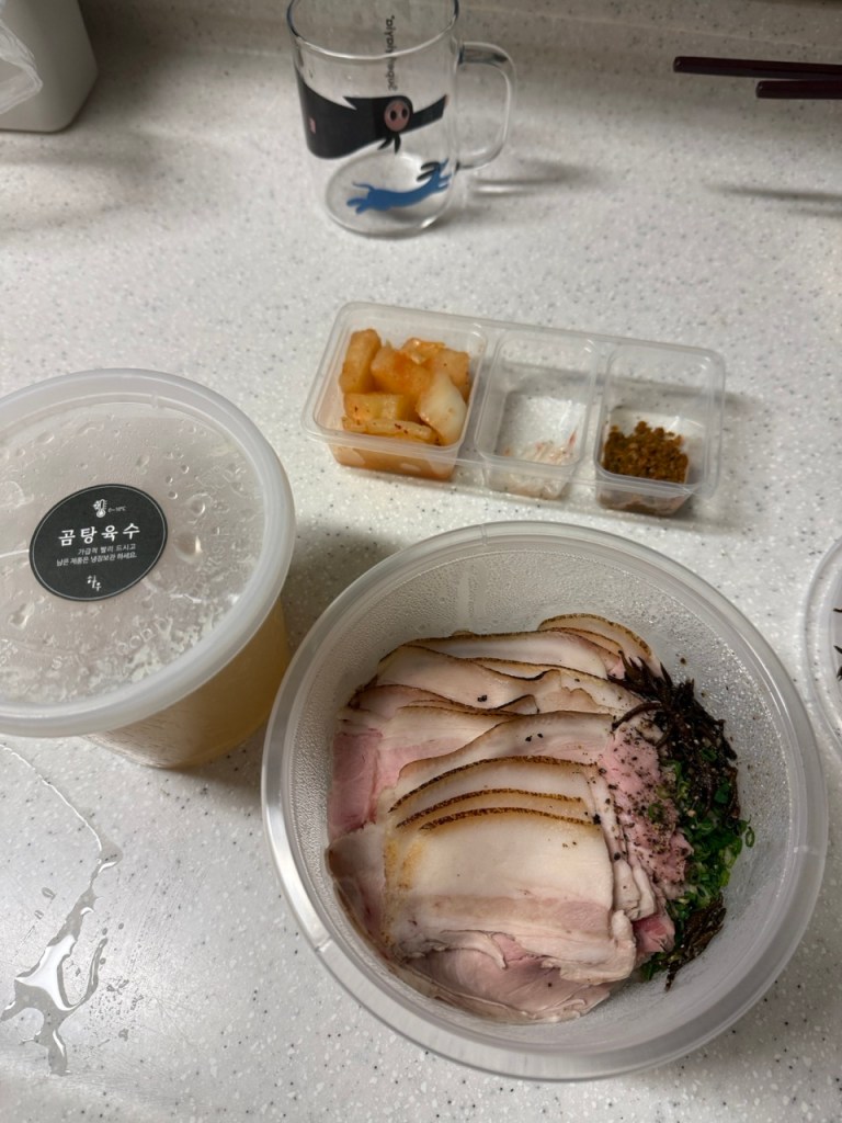 A sleek, high-end presentation of Hau's signature clear pork soup packed beautifully for premium takeout and delivery.