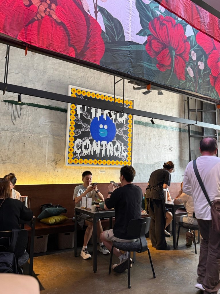 A stylish lifestyle snapshot of young creative professionals clinking wine glasses at a long communal table.