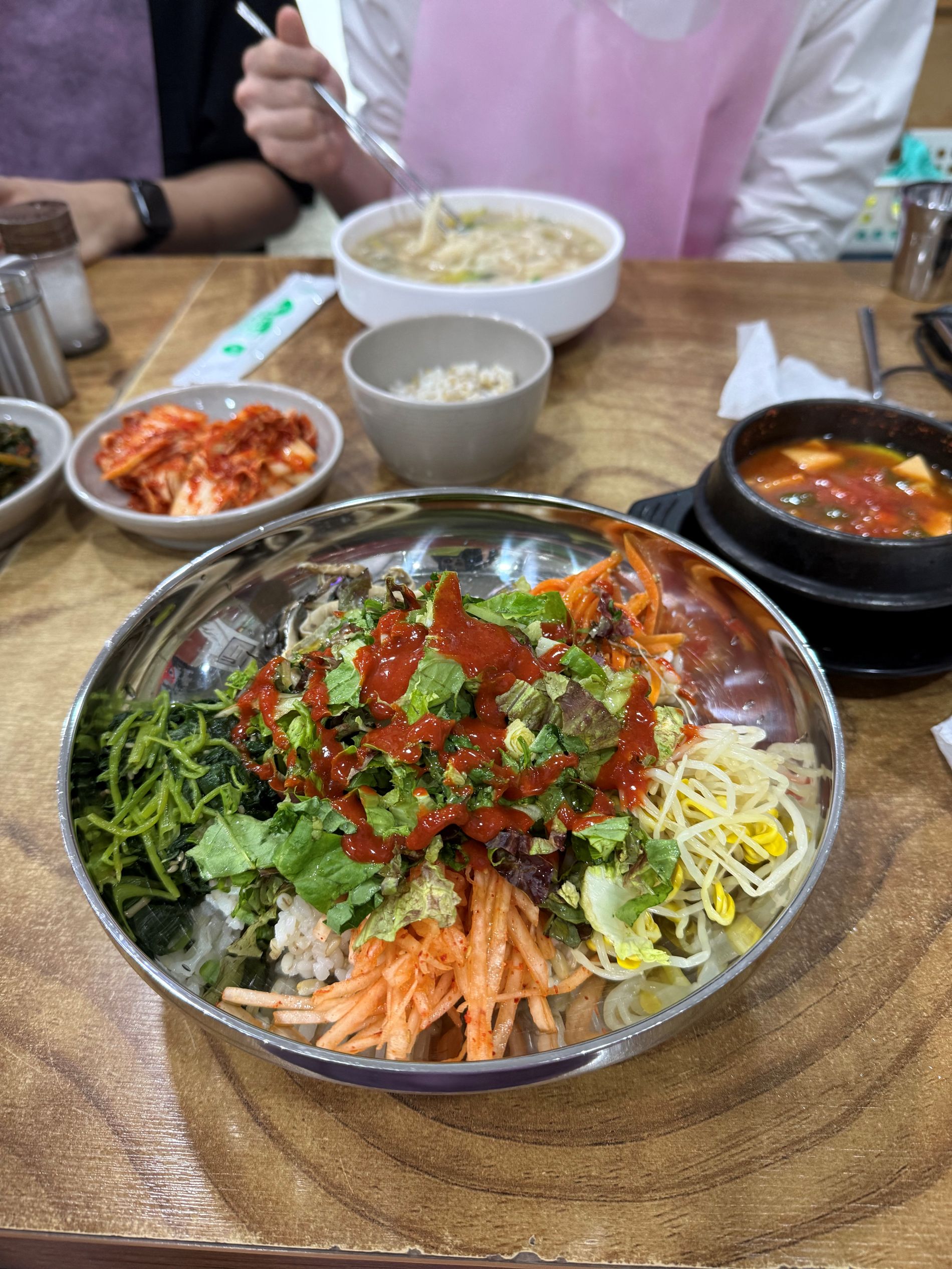 A high-satisfaction macro shot highlighting the fresh, colorful vegetable toppings of the bibimbap.