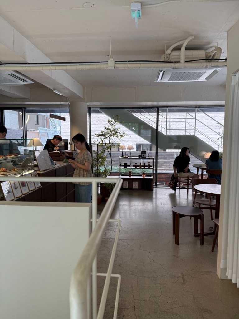 A high-satisfaction look at the rich, dark-toned wooden ordering counter that defines the cafe's cozy reception.