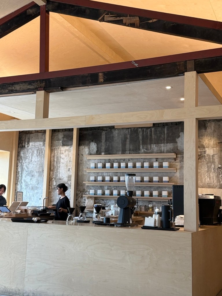 A high-satisfaction macro close-up of a sleek dark wooden bar counter featuring precision pour-over coffee drip stands.