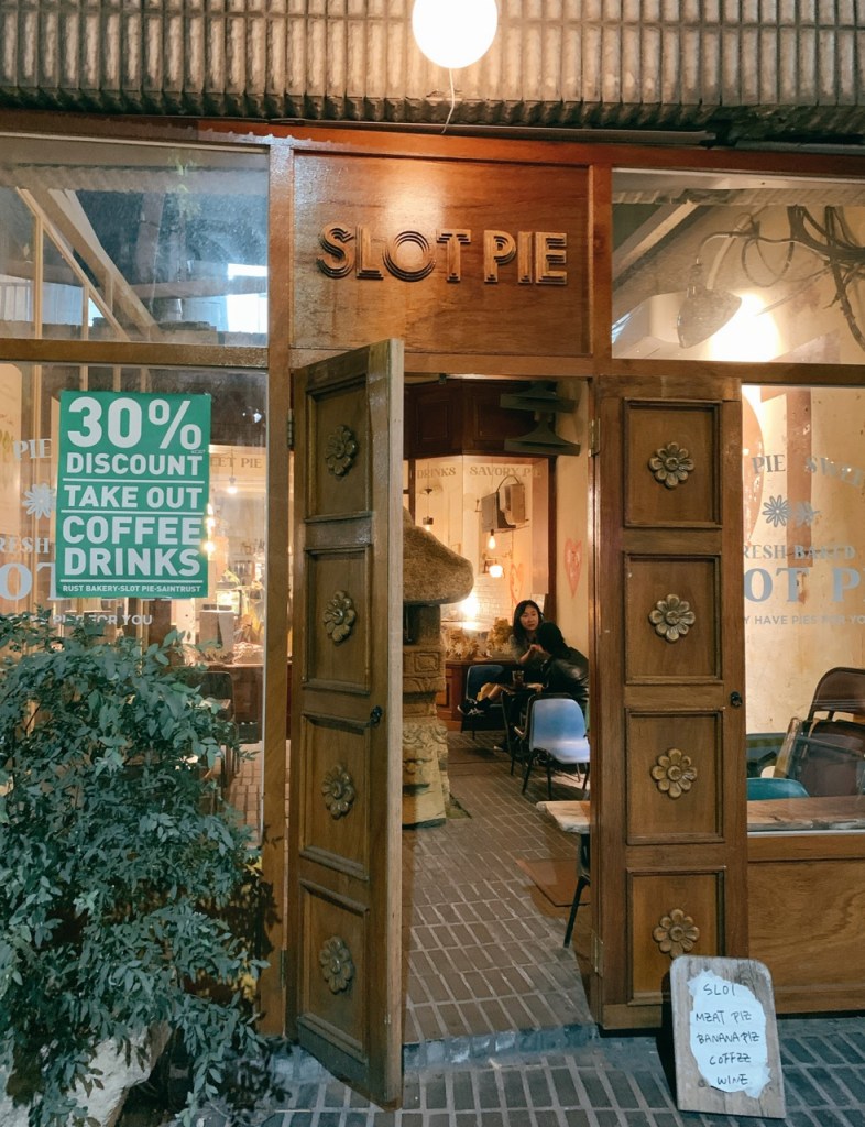 An aesthetic focus on the subtle, tranquil alleyway entrance signboard of Slot cafe tucked in Mullae-dong.