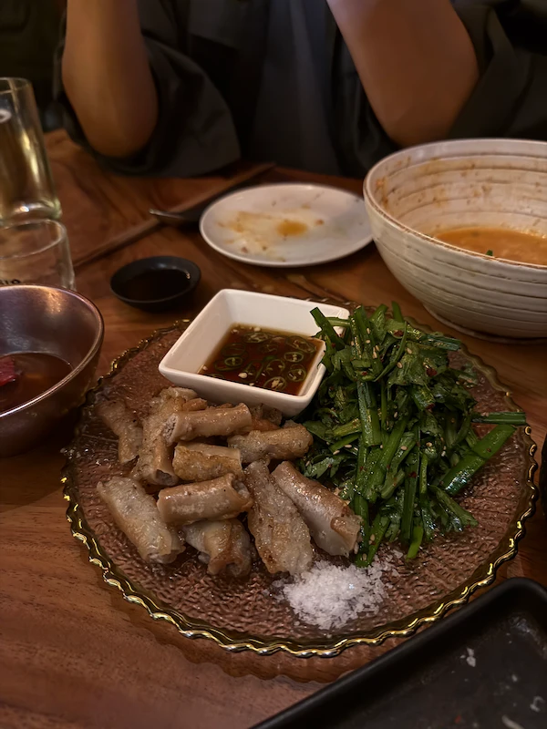 A high-satisfaction top-down view of various modern Korean tapas small plates spread served at Mukmuki.